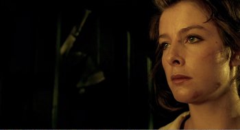 Movie still from “Delicatessen” (1991), directed by Marc Caro – A woman's face in a dark room; Close Up shot, Low angle