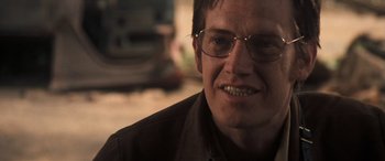 Movie still from “Deliverance” (1972), directed by John Boorman – A person wearing glasses; Close Up shot, Over the shoulder angle