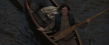 Movie still from “Deliverance” (1972), directed by John Boorman – A man holding a paddle in a canoe; Medium shot, High angle