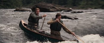 Movie still from “Deliverance” (1972), directed by John Boorman – Two men are rowing a boat in the water; Medium shot, High angle