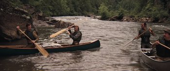 Movie still from “Deliverance” (1972), directed by John Boorman – A man is paddling a canoe down a river; Wide shot, High angle