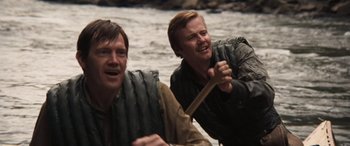Movie still from “Deliverance” (1972), directed by John Boorman – Two men are paddling a raft in the water; Close Up shot, Over the shoulder angle