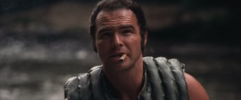 Movie still from “Deliverance” (1972), directed by John Boorman – A person with a cigarette in his mouth; Close Up shot, Low angle