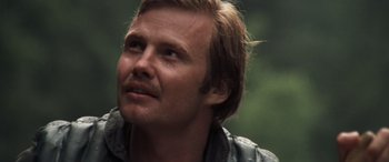 Movie still from “Deliverance” (1972), directed by John Boorman – A person wearing a jacket looking up; Close Up shot, Low angle