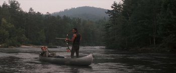 Movie still from “Deliverance” (1972), directed by John Boorman – A man in a canoe on a body of water; Wide shot, High angle