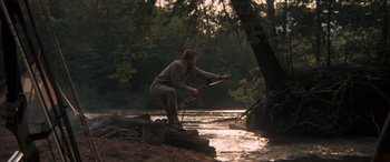 Movie still from “Deliverance” (1972), directed by John Boorman – A man standing on a rock in the water; Wide shot, Over the shoulder angle