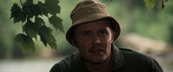 Movie still from “Deliverance” (1972), directed by John Boorman – A person wearing a hat; Close Up shot, Low angle