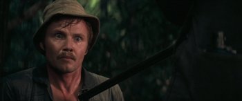 Movie still from “Deliverance” (1972), directed by John Boorman – A person with a hat holding a stick; Close Up shot, Low angle
