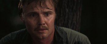 Movie still from “Deliverance” (1972), directed by John Boorman – A person with a beard; Close Up shot, Over the shoulder angle