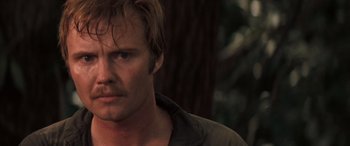 Movie still from “Deliverance” (1972), directed by John Boorman – A man's face in front of a tree; Close Up shot, Low angle