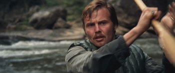 Movie still from “Deliverance” (1972), directed by John Boorman – A person with a beard; Close Up shot, Low angle