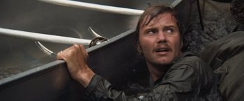 Movie still from “Deliverance” (1972), directed by John Boorman – A person holding a knife; Close Up shot, Low angle