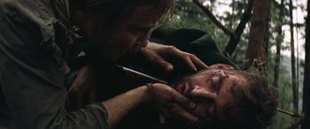 Movie still from “Deliverance” (1972), directed by John Boorman – A man is shaving another man's face with a knife; Close Up shot, Over the shoulder angle