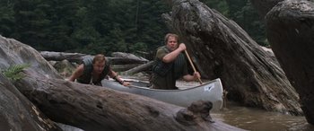 Movie still from “Deliverance” (1972), directed by John Boorman – Two people in a canoe on a body of water; Wide shot, High angle