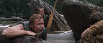Movie still from “Deliverance” (1972), directed by John Boorman – Two men are in a canoe in the woods; Medium shot, Low angle