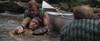 Movie still from “Deliverance” (1972), directed by John Boorman – Two men are in a boat in the water; Close Up shot, Over the shoulder angle