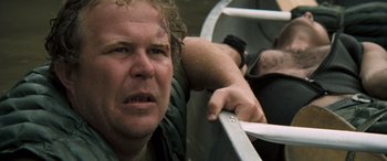 Movie still from “Deliverance” (1972), directed by John Boorman – A person leaning on a railing; Close Up shot, Low angle