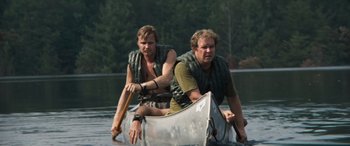 Movie still from “Deliverance” (1972), directed by John Boorman – A couple of men are in a canoe in the water; Medium shot, Low angle