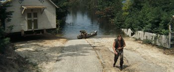 Movie still from “Deliverance” (1972), directed by John Boorman – Two men are standing on the side of the road; Wide shot, High angle