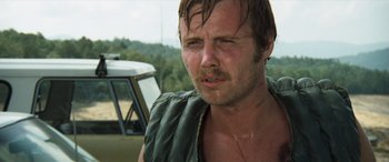 Movie still from “Deliverance” (1972), directed by John Boorman – A person wearing a vest; Close Up shot, Low angle