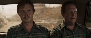 Movie still from “Deliverance” (1972), directed by John Boorman – Two men sitting in the back seat of a car; Close Up shot, Over the shoulder angle