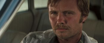 Movie still from “Deliverance” (1972), directed by John Boorman – A person with a mustache; Close Up shot, Low angle