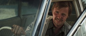 Movie still from “Deliverance” (1972), directed by John Boorman – A person in a car; Close Up shot, Low angle