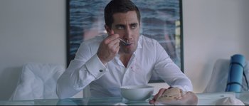 Movie still from “Demolition” (2015), directed by Jean-Marc Vallée – A man sitting at a table with a bowl of food; Medium shot, Over the shoulder angle