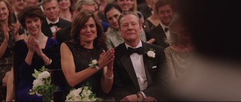 Movie still from “Demolition” (2015), directed by Jean-Marc Vallée – A man and a woman clapping at an event; Medium shot, Over the shoulder angle