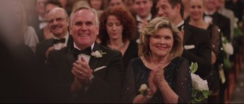 Movie still from “Demolition” (2015), directed by Jean-Marc Vallée – A man and a woman clapping at a formal event; Close Up shot, Over the shoulder angle