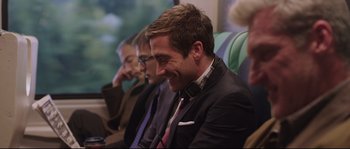 Movie still from “Demolition” (2015), directed by Jean-Marc Vallée – A man in a suit and tie sitting next to another man; Medium shot, Over the shoulder angle