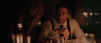 Movie still from “Demolition” (2015), directed by Jean-Marc Vallée – A man sitting at a table with a glass of wine in front of him; Close Up shot, Over the shoulder angle