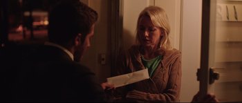 Movie still from “Demolition” (2015), directed by Jean-Marc Vallée – A man and a woman holding a piece of paper; Medium shot, Over the shoulder angle
