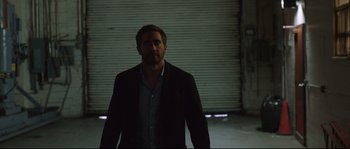 Movie still from “Demolition” (2015), directed by Jean-Marc Vallée – A man standing in a dark room in front of a door; Medium shot, Over the shoulder angle
