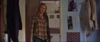 Movie still from “Demolition” (2015), directed by Jean-Marc Vallée – A woman standing in front of a wall in a room; Medium shot, Over the shoulder angle