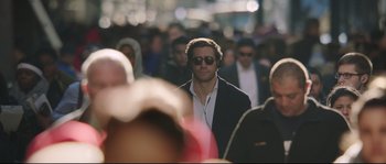 Movie still from “Demolition” (2015), directed by Jean-Marc Vallée – A crowd of people walking down a street; Medium shot, Over the shoulder angle