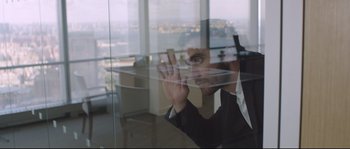 Movie still from “Demolition” (2015), directed by Jean-Marc Vallée – A man in a suit looking out a window; Medium shot, Over the shoulder angle
