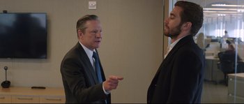 Movie still from “Demolition” (2015), directed by Jean-Marc Vallée – A man in a suit and tie talking to another man in a suit and tie; Medium shot, Over the shoulder angle