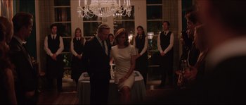 Movie still from “Demolition” (2015), directed by Jean-Marc Vallée – A man and a woman standing next to each other in front of a chandelier; Medium shot, Over the shoulder angle