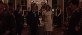 Movie still from “Demolition” (2015), directed by Jean-Marc Vallée – A man and a woman standing next to each other in front of a chandelier; Medium shot, Over the shoulder angle