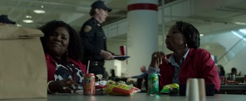 Movie still from “Den of Thieves” (2018), directed by Christian Gudegast – A police officer sitting at a table in front of a woman; Medium shot, Over the shoulder angle