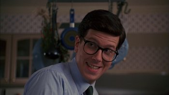 Movie still from “Dennis the Menace” (1993), directed by Nick Castle – A man wearing glasses and a shirt and tie; Close Up shot, Low angle