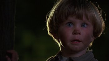 Movie still from “Dennis the Menace” (1993), directed by Nick Castle – A young child with blue eyes; Close Up shot, High angle