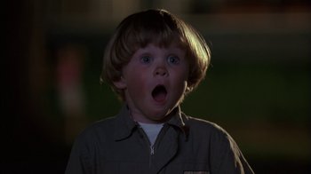 Movie still from “Dennis the Menace” (1993), directed by Nick Castle – A young boy with a surprised look on his face; Close Up shot, Low angle