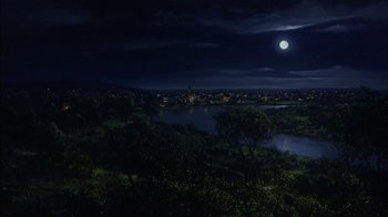 Movie still from “Dennis the Menace” (1993), directed by Nick Castle – A full moon over a city at night; Extreme Wide shot, High angle