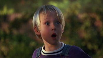 Movie still from “Dennis the Menace” (1993), directed by Nick Castle – A young boy with a surprised look on his face; Close Up shot, Low angle