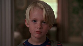 Movie still from “Dennis the Menace” (1993), directed by Nick Castle – A young boy with blonde hair; Close Up shot, High angle