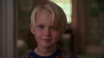 Movie still from “Dennis the Menace” (1993), directed by Nick Castle – A young boy with blonde hair; Close Up shot, High angle