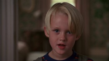 Movie still from “Dennis the Menace” (1993), directed by Nick Castle – A young boy with blonde hair; Close Up shot, Low angle