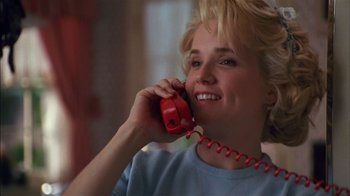 Movie still from “Dennis the Menace” (1993), directed by Nick Castle – A woman talking on a red phone while smiling; Close Up shot, Low angle